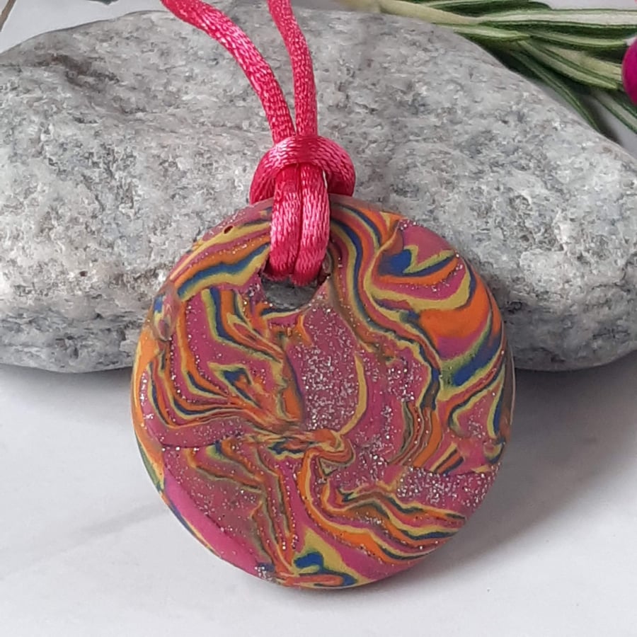 Handmade hot pink and orange multi coloured polymer clay round pendant 