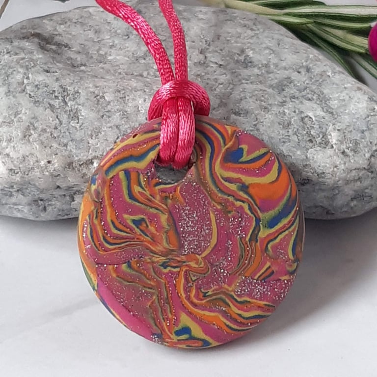 Handmade hot pink and orange multi coloured polymer clay round pendant 