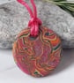 Handmade hot pink and orange multi coloured polymer clay round pendant 