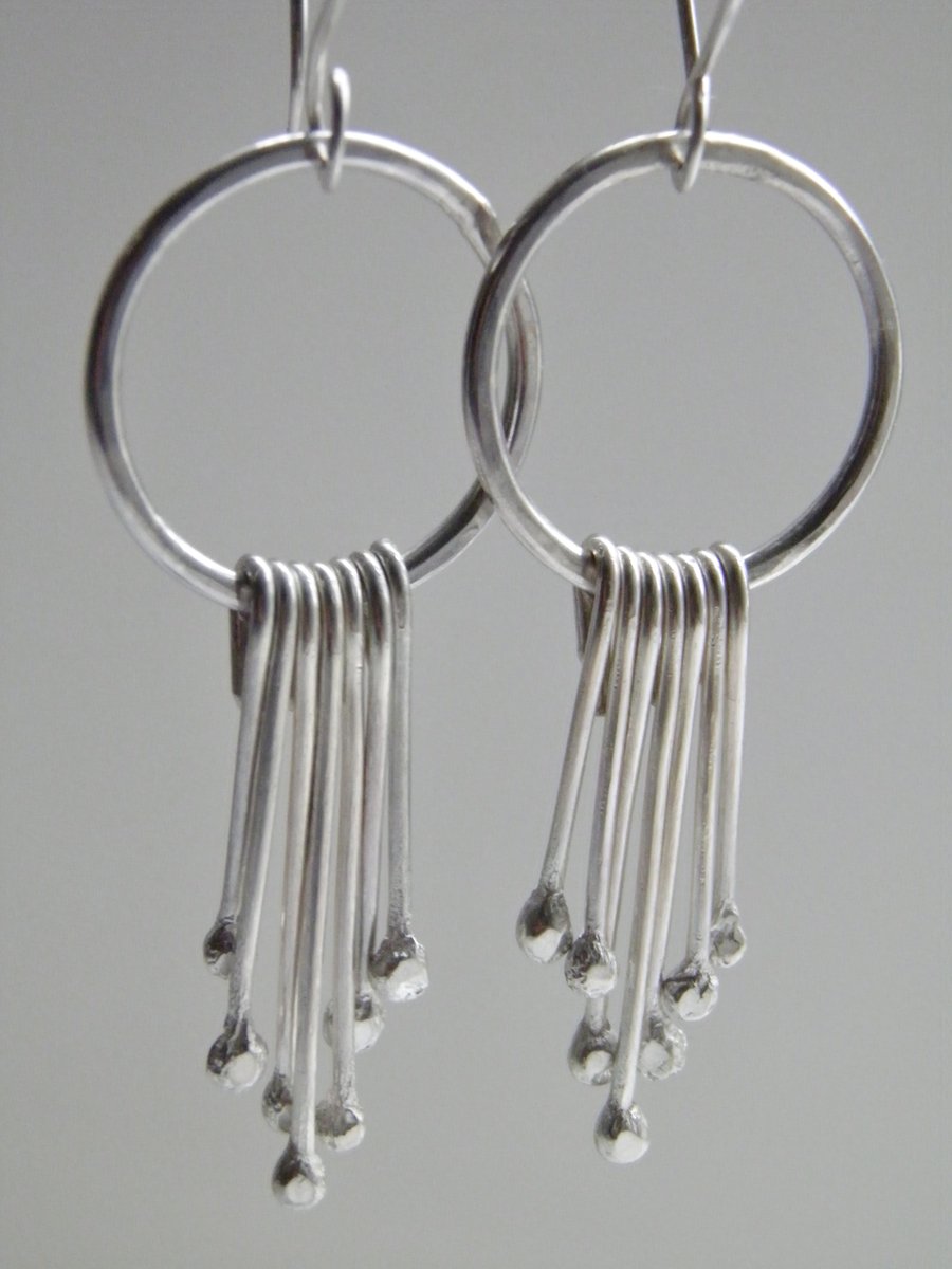 Sterling Silver Earrings with Dangle Hoop Design.