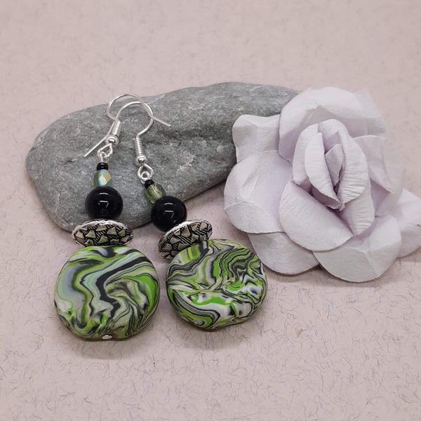 Polymer clay earrings in a green, silver, white and black swirl design