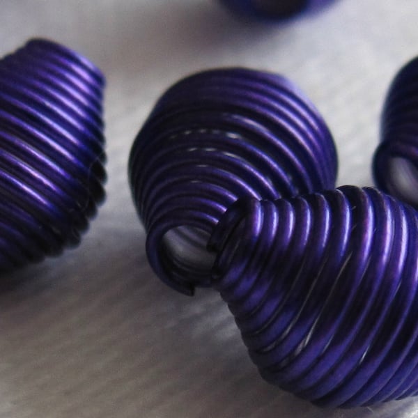 A Pack of Purple Oval Shaped Coil Beads