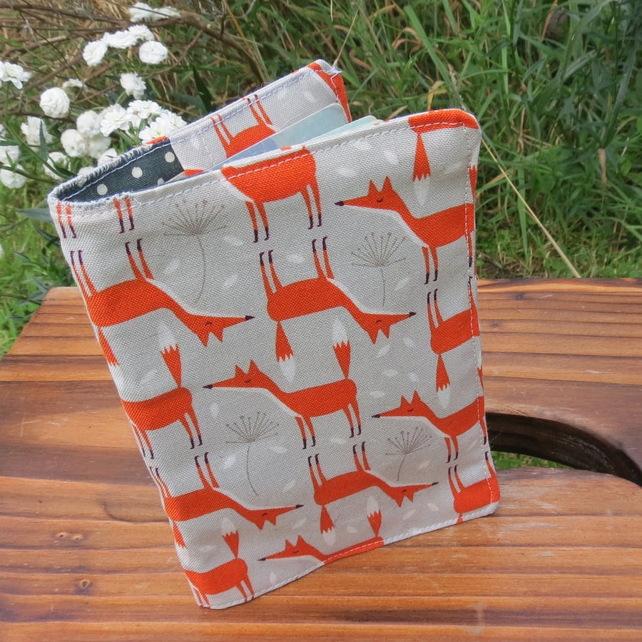 A fabric passport cover with a whimsical fox design.  Travel accessories.