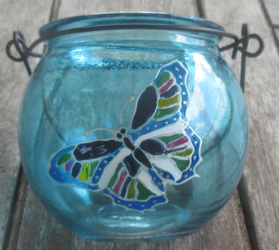 Cauldron shaped blue tea light holder with hand painted butterfly