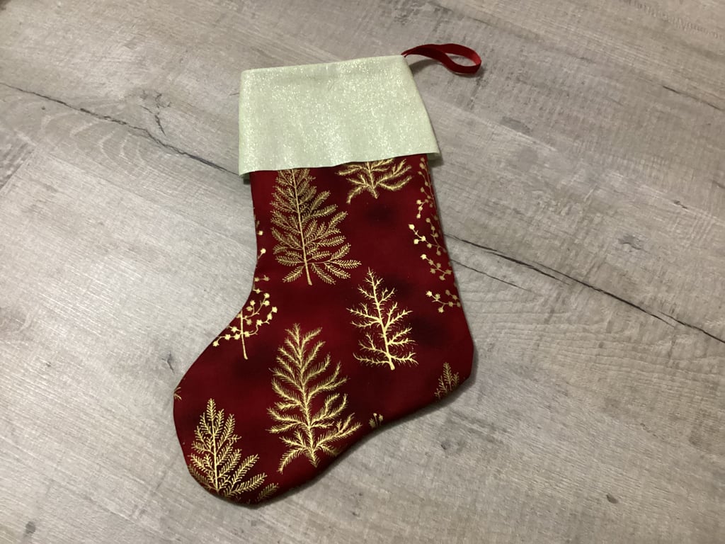 Christmas stocking in red and gold, Christmas trees.