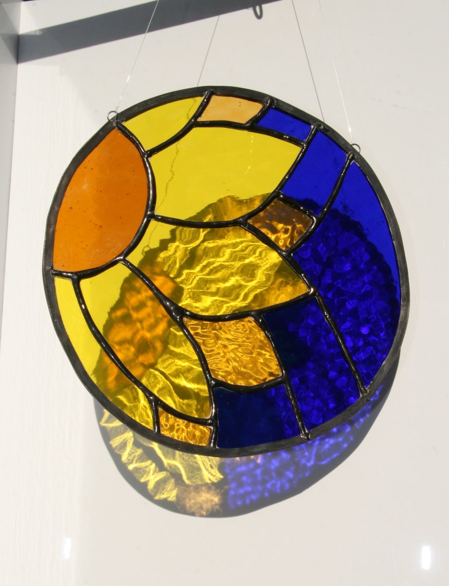 Sun catcher Stained glass sunflower on rich blue background 