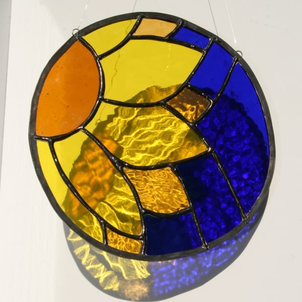 Sun catcher Stained glass sunflower on rich blue background 