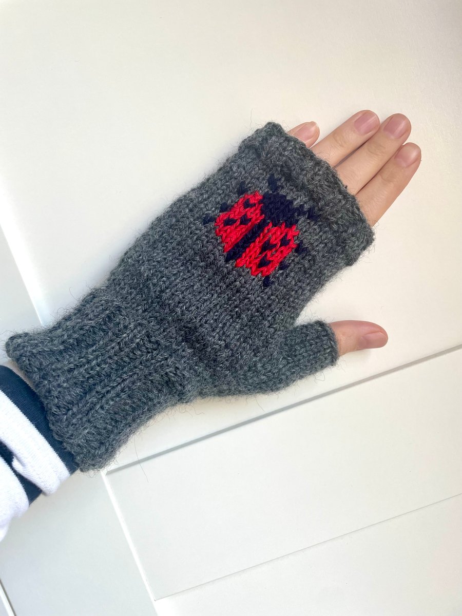 Handknit dark grey wool fingerless gloves with embroidered ladybird