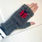 Handknit dark grey wool fingerless gloves with embroidered ladybird
