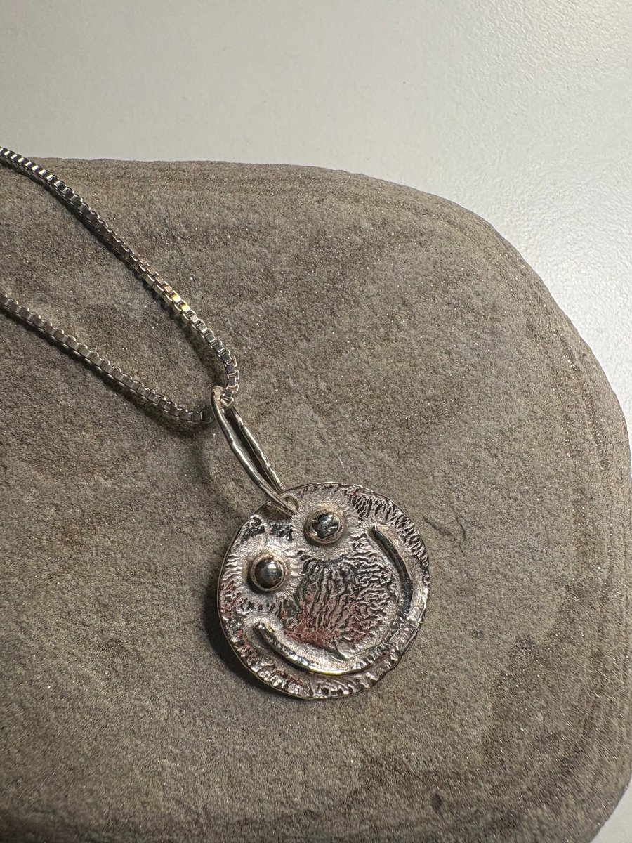 Melty smiley face pendant with sterling silver chain