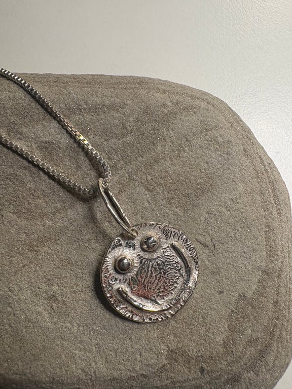 Melty smiley face pendant with sterling silver chain