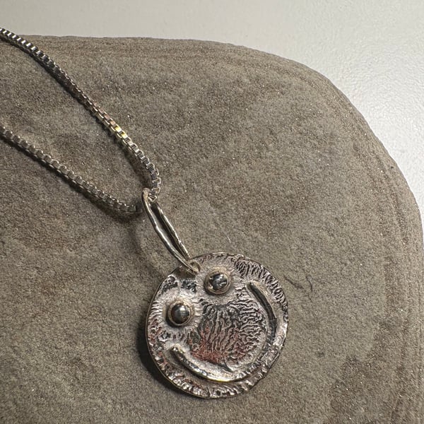 Melty smiley face pendant with sterling silver chain