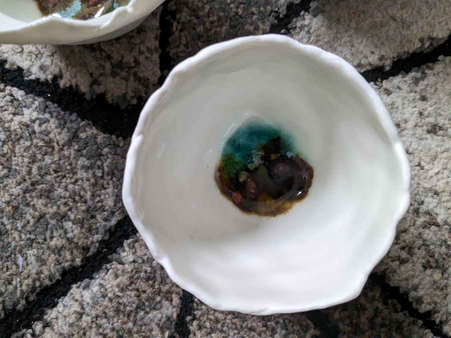 Handmade porcelain small pots with splashes of glaze