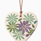 Ceramic heart with hand drawn design.