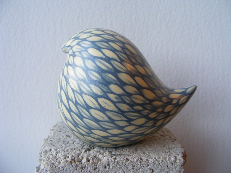 Round painted bird (cream on pale blue)