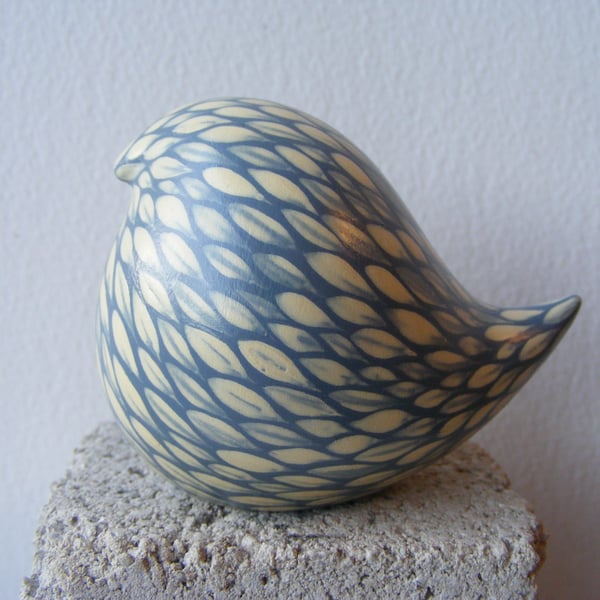 Round painted bird (cream on pale blue)