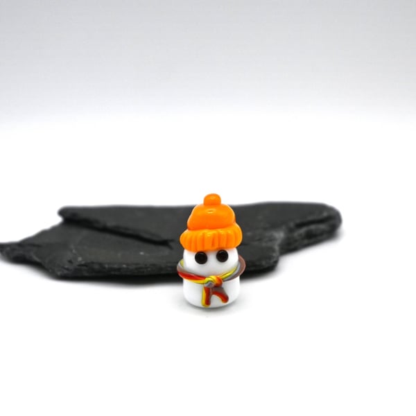 small glass ghost wearing a hat figure