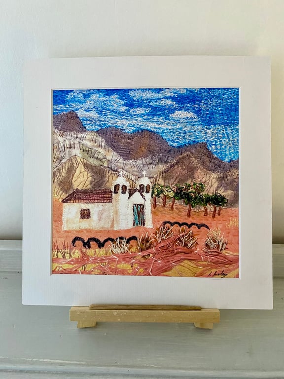 A place to gather, little white church set in a desert landscape 
