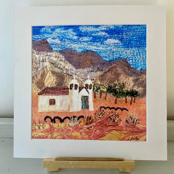 A place to gather, little white church set in a desert landscape 