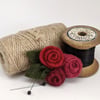 Small felted roses brooch in shades of red