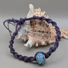 Handmade macrame bracelet with a lamp work glass bead 