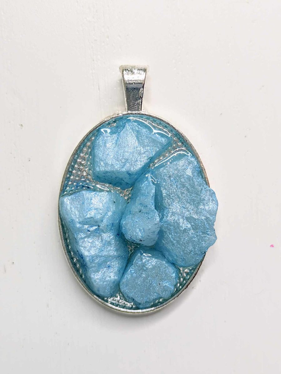 Oval Resin Pendant With Small Blue Rocks