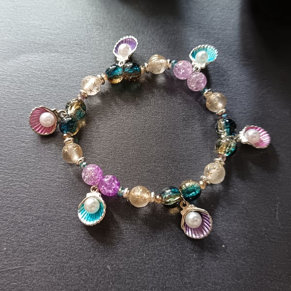 Elasticated bracelet with multicoloured beads and shell and pearl charms 