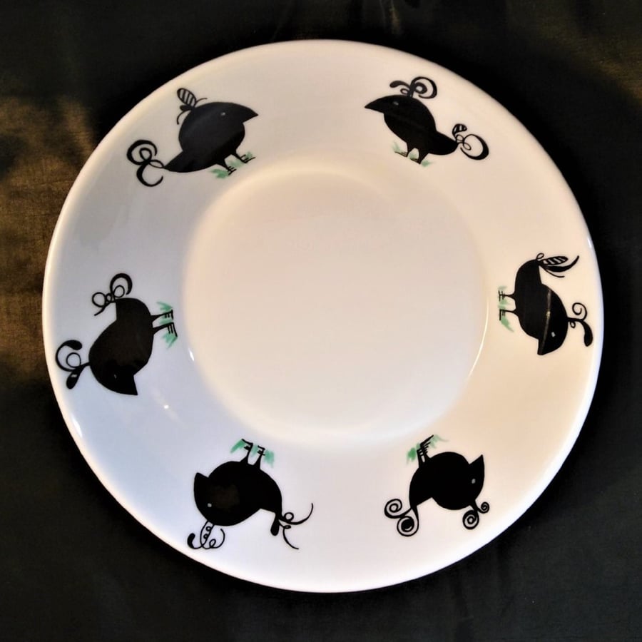 A dessert or soup bowl or dish of white bone china decorated with six black abst