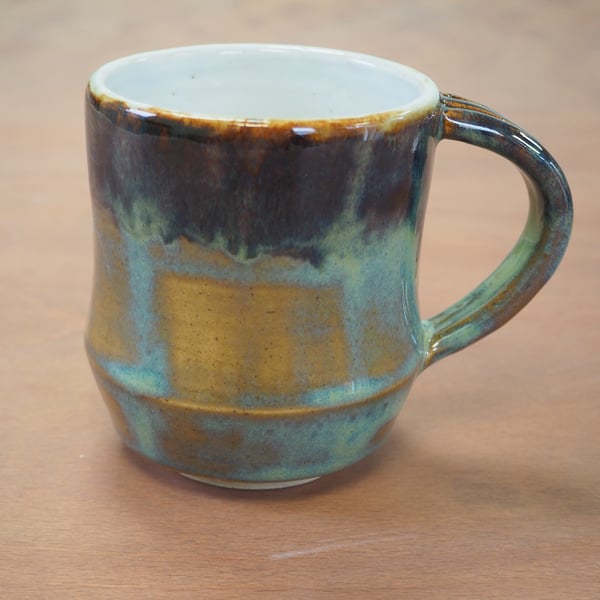  Stoneware pottery mug finished in a turquoise, blue and brown multicolour glaze