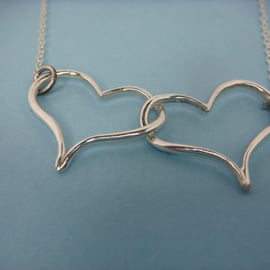 Double Heart pendant in fine silver with sterling silver trace chain.