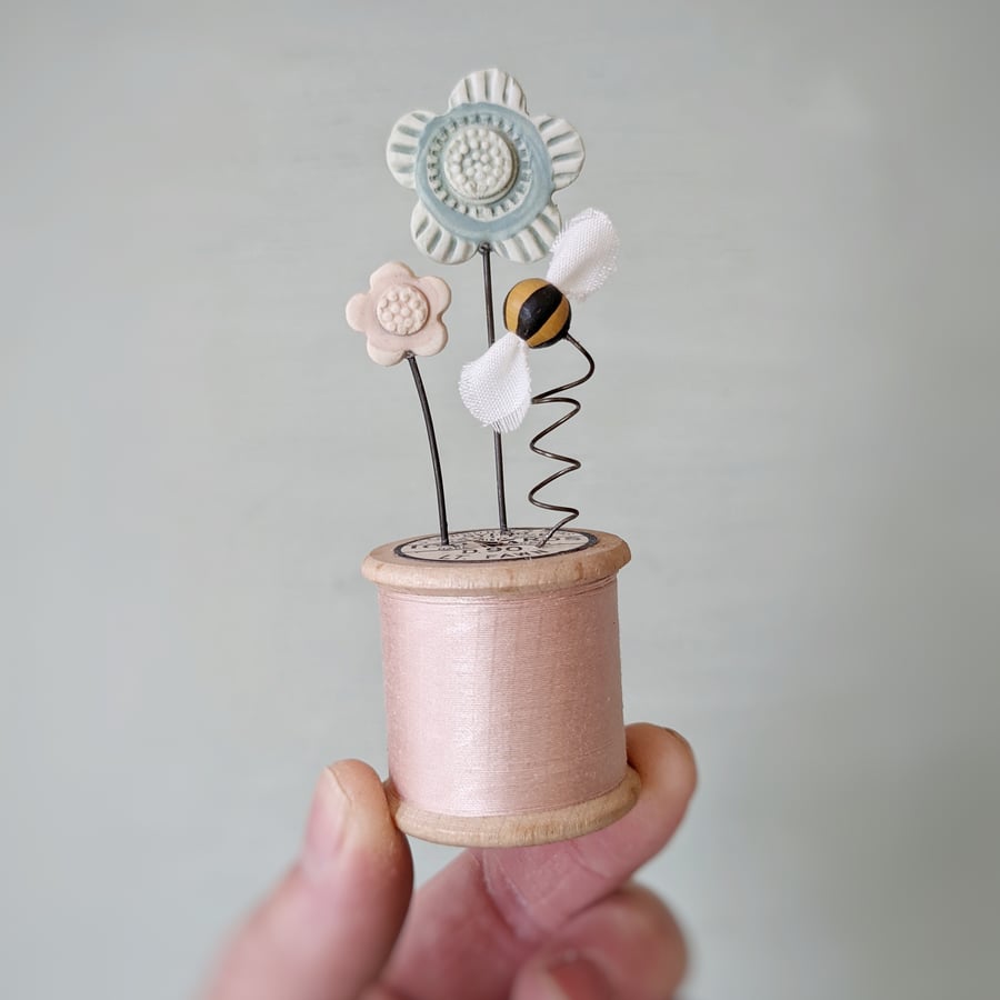 Clay Flowers and Bee on a Vintage Bobbin