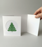 Hand-stitched Christmas card with embroidered green Christmas tree 