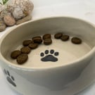 Dog bowl featuring bones and paw prints