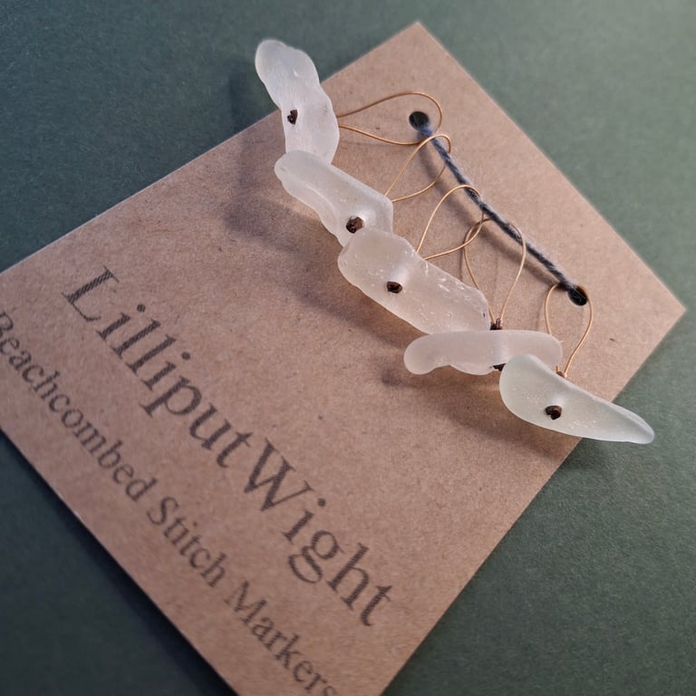 Five white sea glass stitch markers