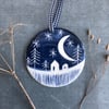 Ceramic Winter scene hanging decoration.