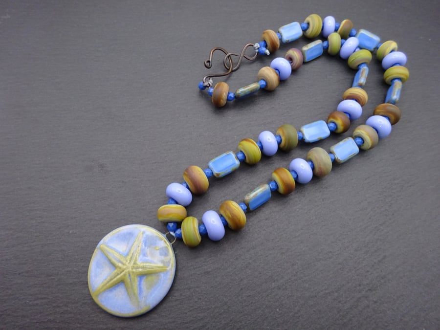 ceramic starfish necklace, blue lampwork glass