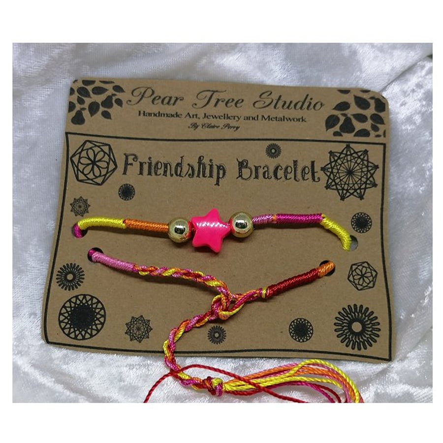 Friendship bracelet with pink star bead.