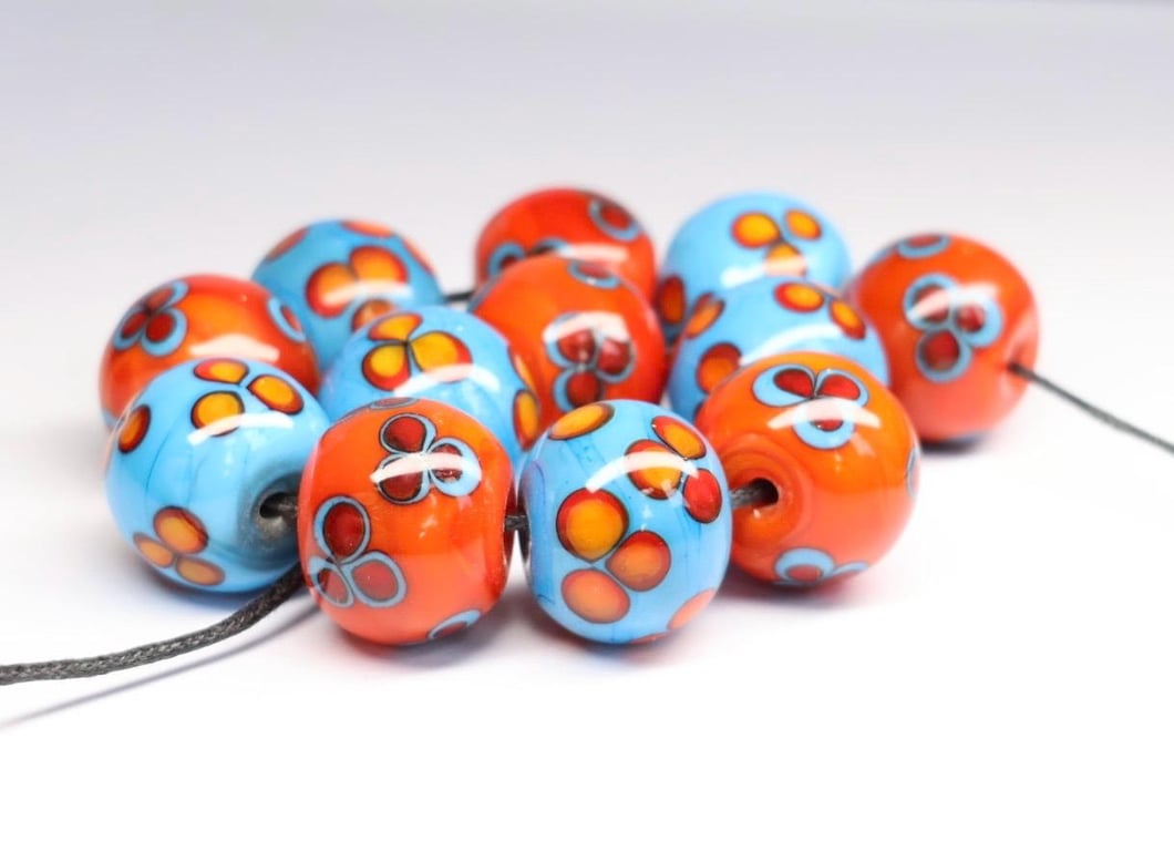 Handmade turquoise and orange floral patterned lamp work glass beads
