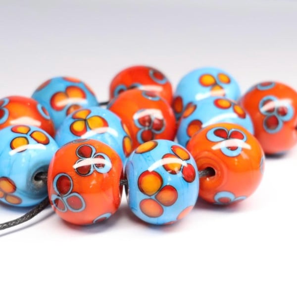 Handmade turquoise and orange floral patterned lamp work glass beads