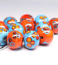 Handmade turquoise and orange floral patterned lamp work glass beads