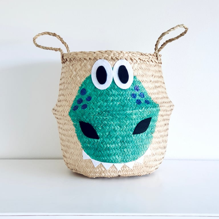 Green dinosaur belly basket. Hand woven from natural seagrass and hand painted