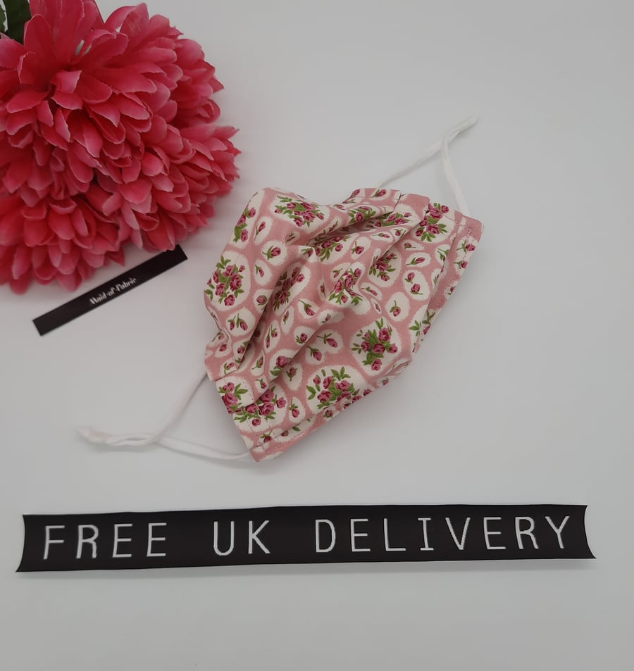 Face mask,  small, 3 layer, adjustable, washable in pink and white flowers. 