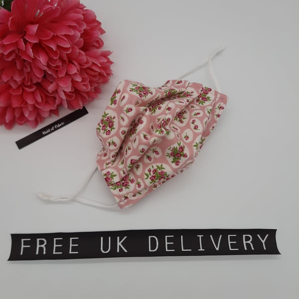 Face mask,  small, 3 layer, adjustable, washable in pink and white flowers. 