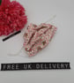 Face mask,  small, 3 layer, adjustable, washable in pink and white flowers.  - Image 1