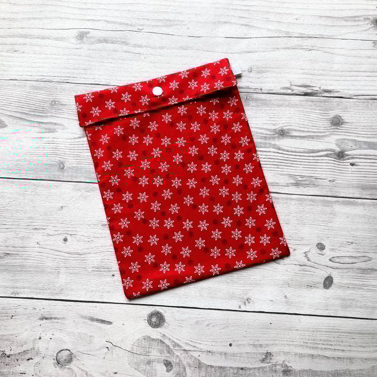 Snowflake Christmas themed red cotton fabric gift bags with snap closure. 