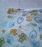 Babies Dribble Bib with Bottles, Bibs and Bootees in Blue on a Cream Background - Image 2