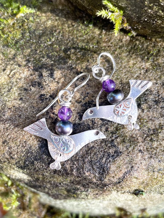 Silver bird earrings with amethyst and black pearl.