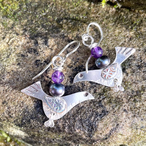 Silver bird earrings with amethyst and black pearl.