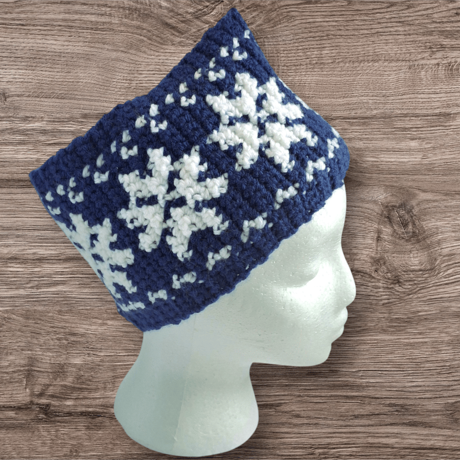 Handcrafted crochet earwarmer with a snowflake design. Blue-white or green-white