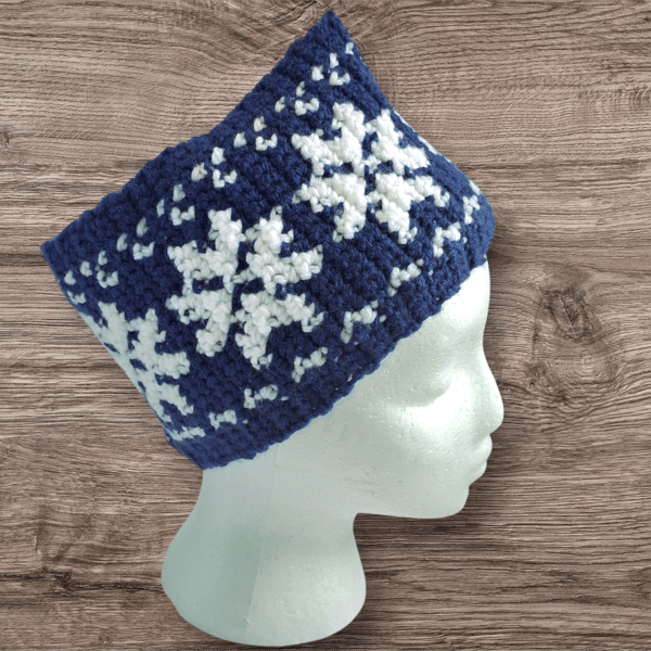 Handcrafted crochet earwarmer with a snowflake design. Blue-white or green-white